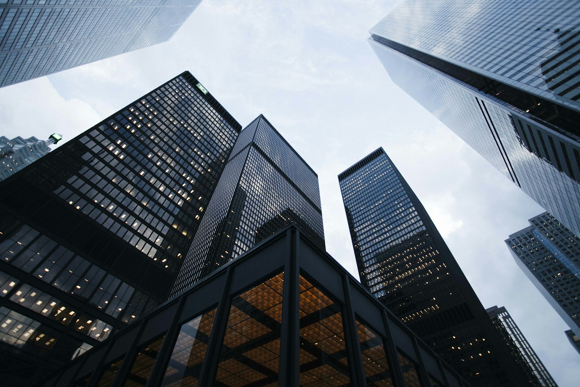 Looking up at a cluster of corporate skyscrapers in a downtown financial district