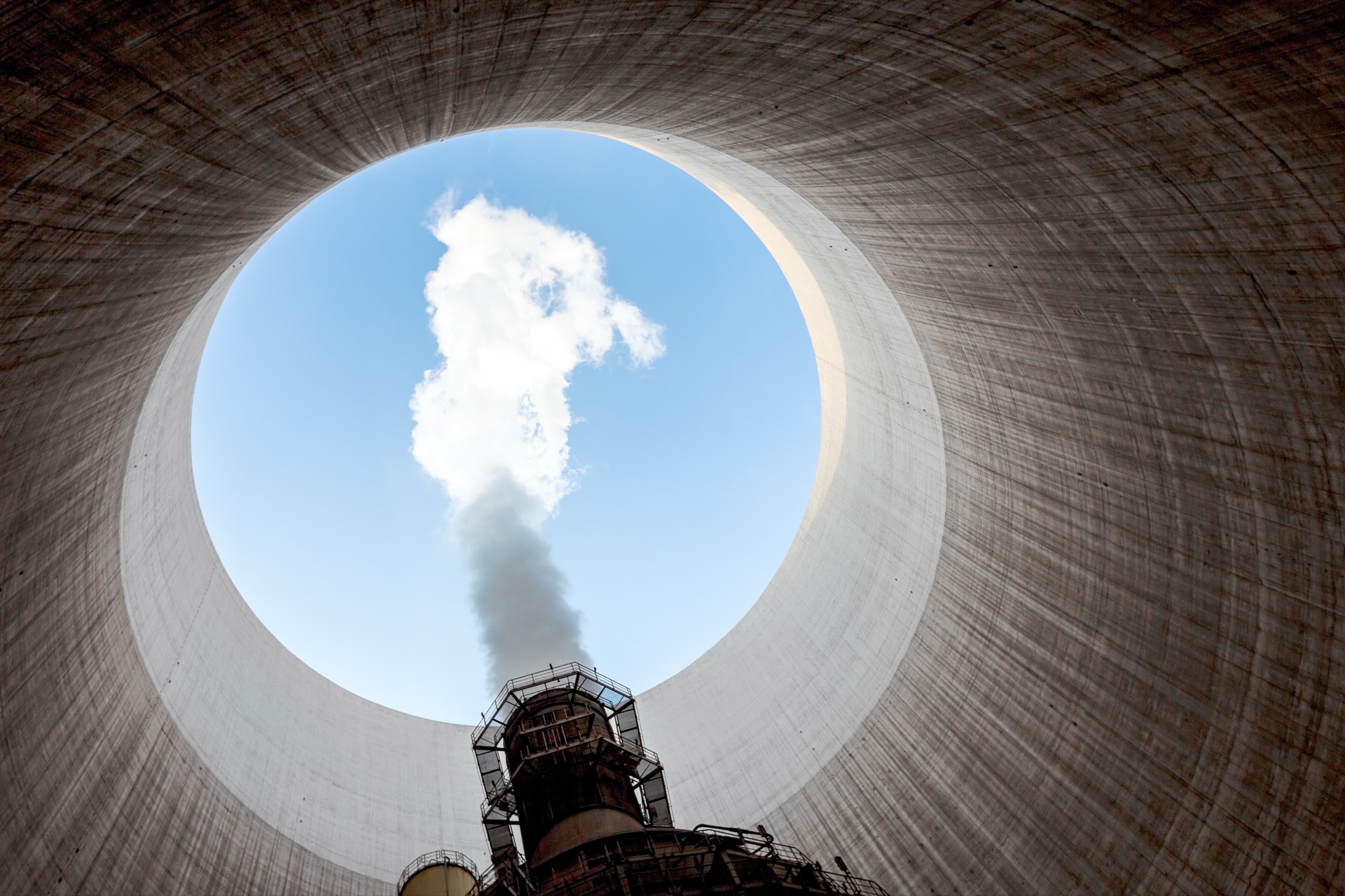Looking up through the interior of a nuclear plant cooling tower toward the sky